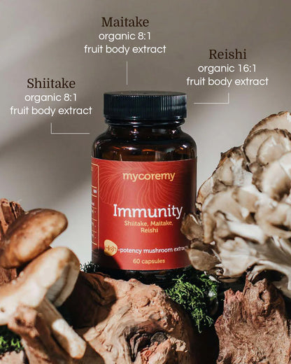 Mycoremy Immunity supplement bottle with Shiitake, Maitake, and Reishi extracts highlighted on a moss-covered log